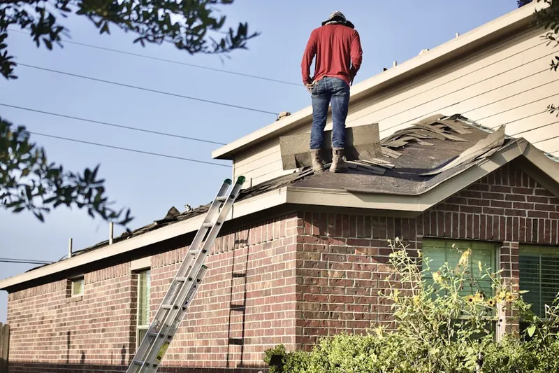 Professional roofer working on a residential roof in Alvarado Historic District